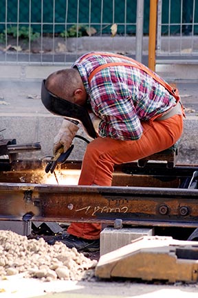 Railroad workers like the one pictured here often suffer injuries at work. Contact a FELA Attorney today to learn your rights.
