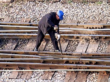 This rail worker faces many dangers every day. If you have been injured while working for a railroad company, call a Houston FELA attorney now.
